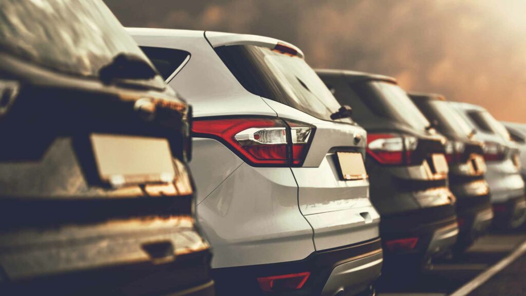 Closeup of the backs of parked cars in a parking lot